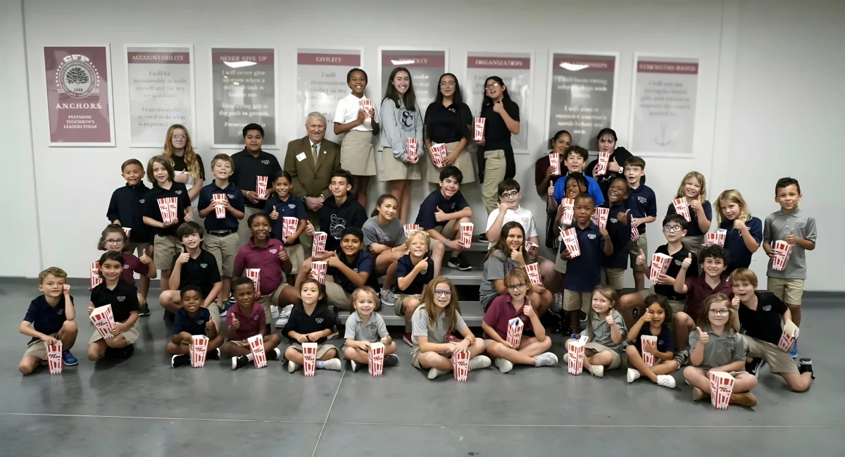 The whole school together in front of the values wall
