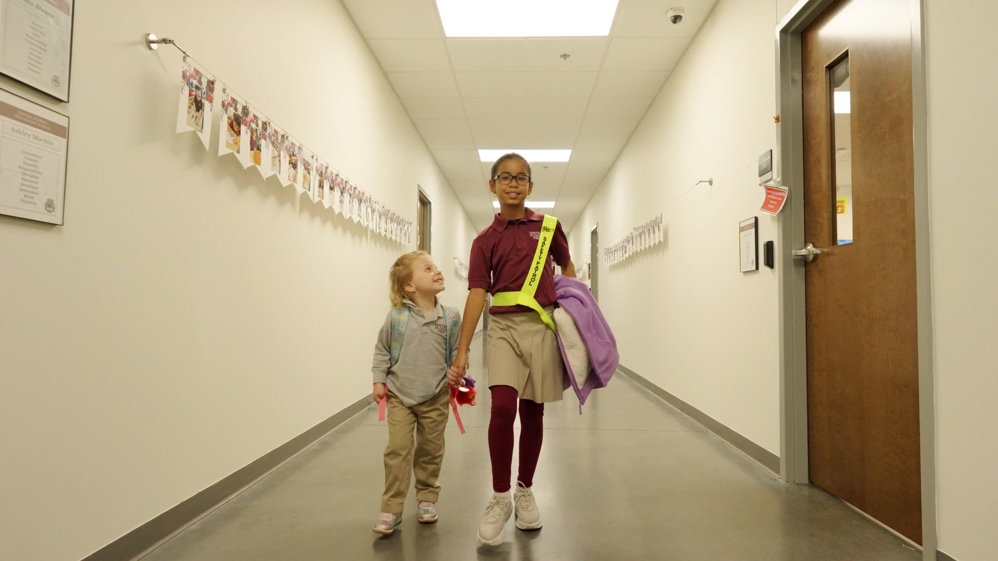 Students walking down a hallway at one of our schools
