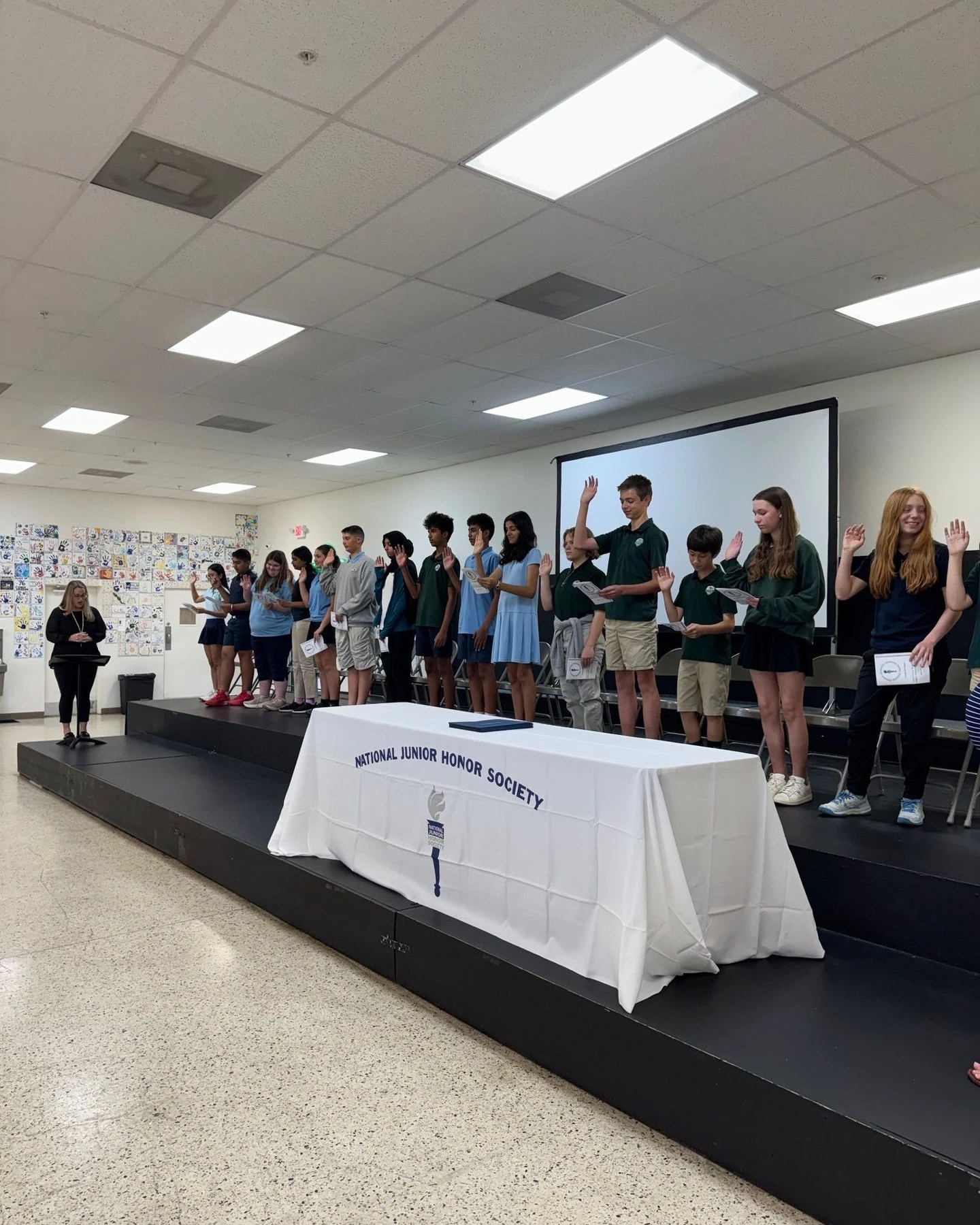 Middle school students lined up on stage at the National Junior Honor Society induction